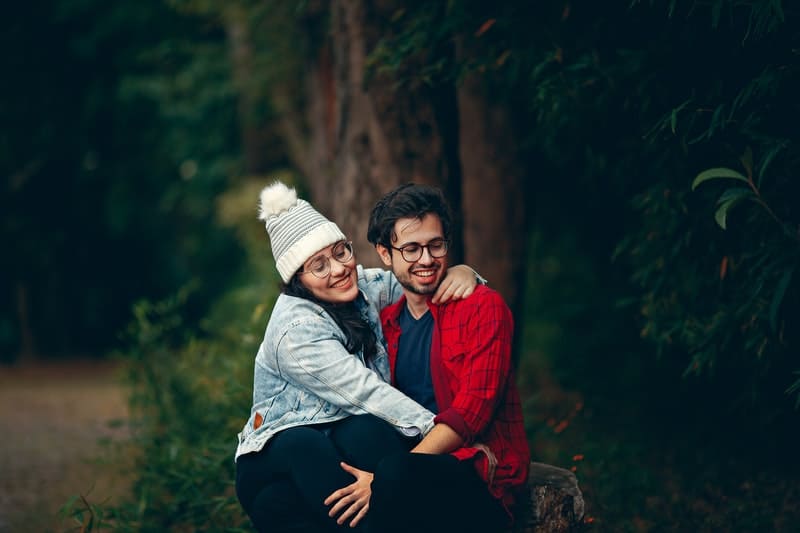 un couple amoureux assis dans les bois