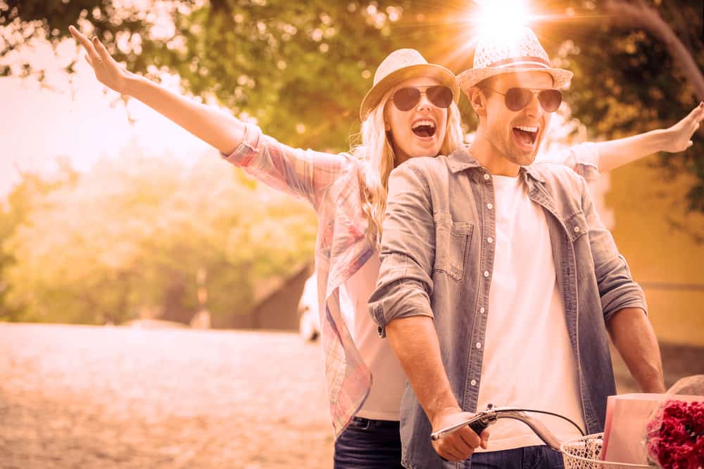 un homme et une femme font du vélo et rient