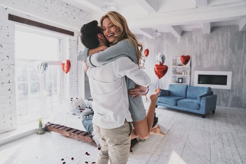 couple heureux, étreindre, dans, salle de séjour