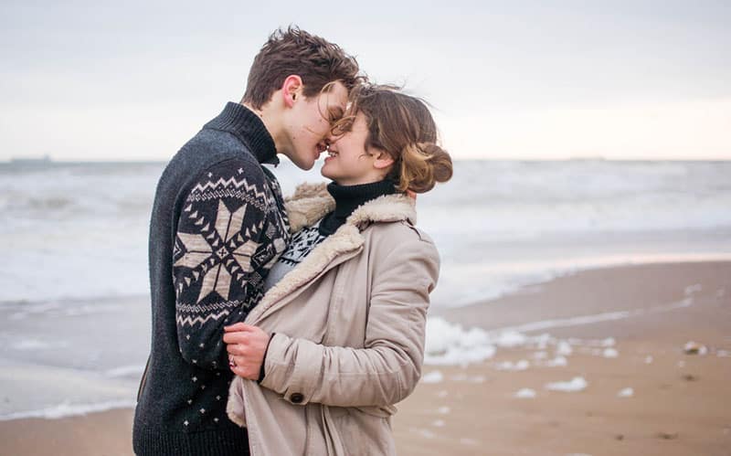 heureux jeune couple s'embrassant sur la plage