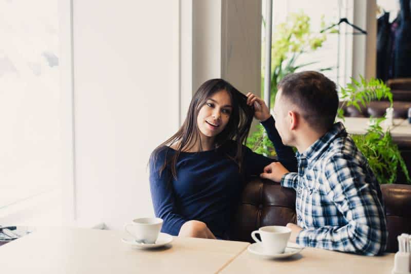Un couple heureux parle au café, boit du thé