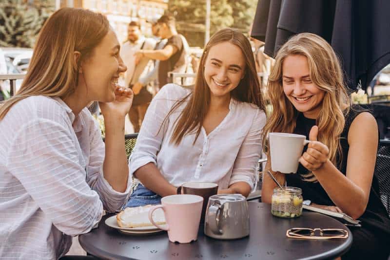 de jolies filles sur la terrasse du café d'été