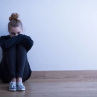 Une femme triste et dépressive assise sur le sol