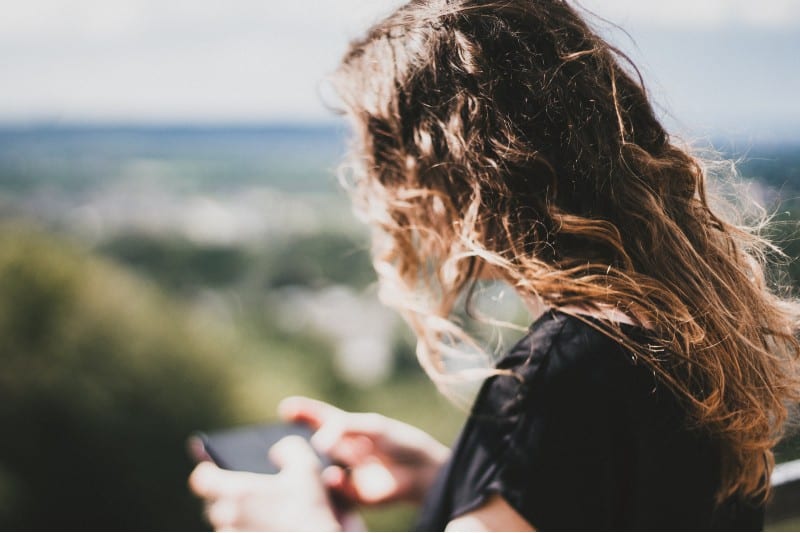 une femme écrivant un message sur le téléphone