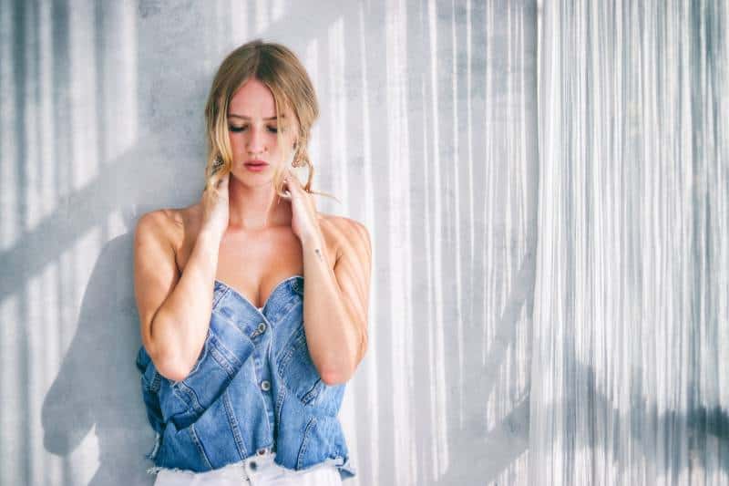 Femme debout près d'un mur