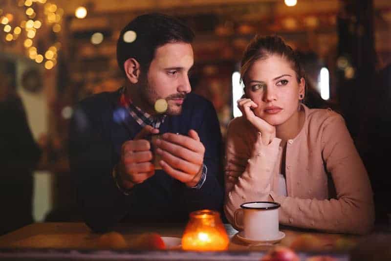 Un homme regarde sa petite amie attentionnée dans un café