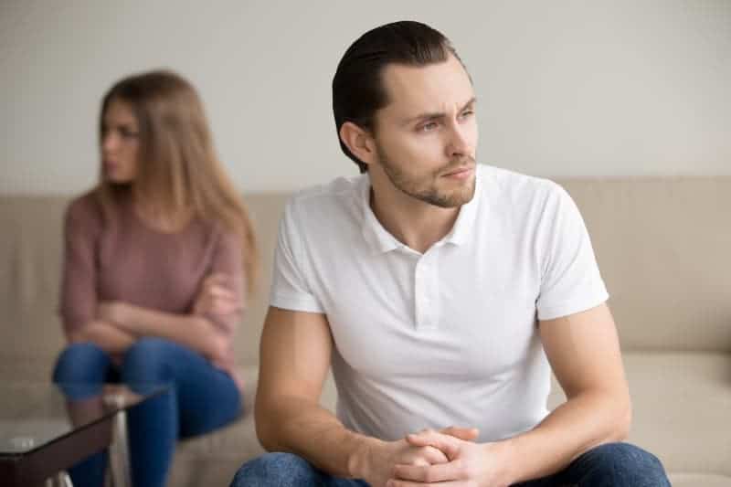 un homme réfléchi assis devant une femme