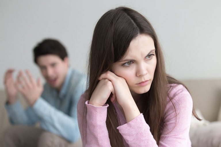 Femme triste assise devant son petit ami en colère