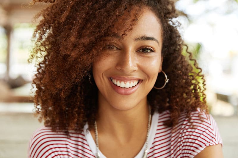 belle femme aux cheveux bouclés posant