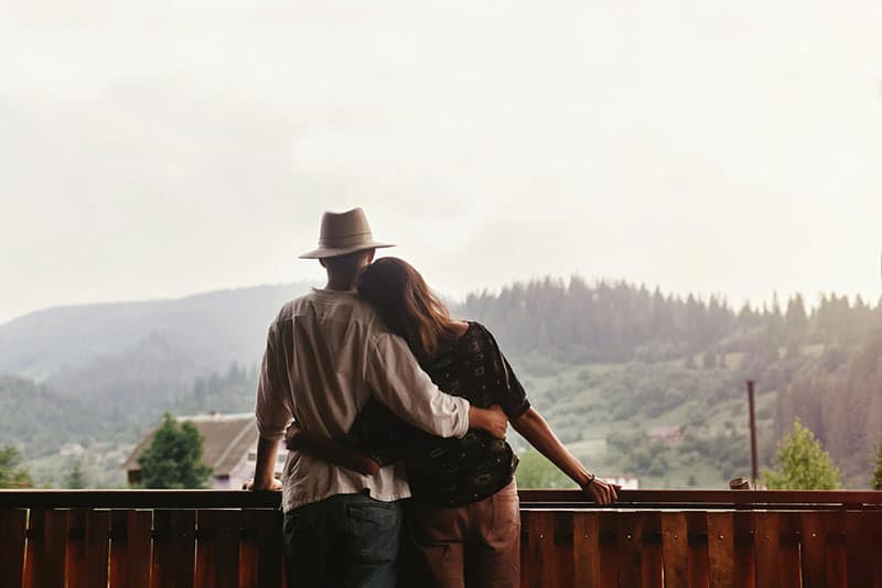 couple étreignant et regardant les montagnes