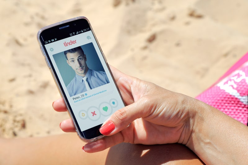 fille visitant le profil d'un homme sur le réseau social tinder