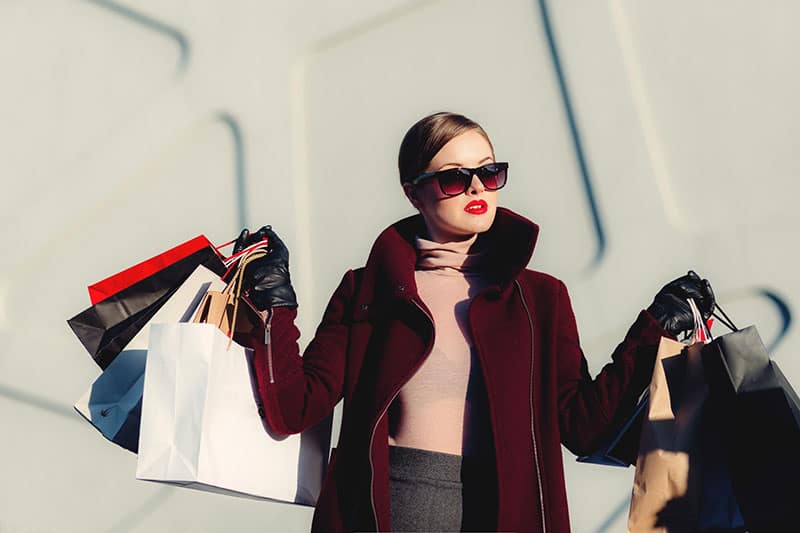 jolie femme debout avec des sacs à provisions