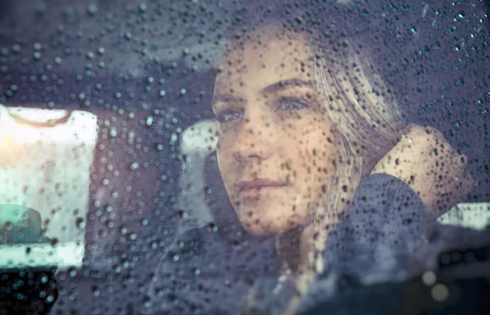 la femme regarde par la fenêtre en conduisant