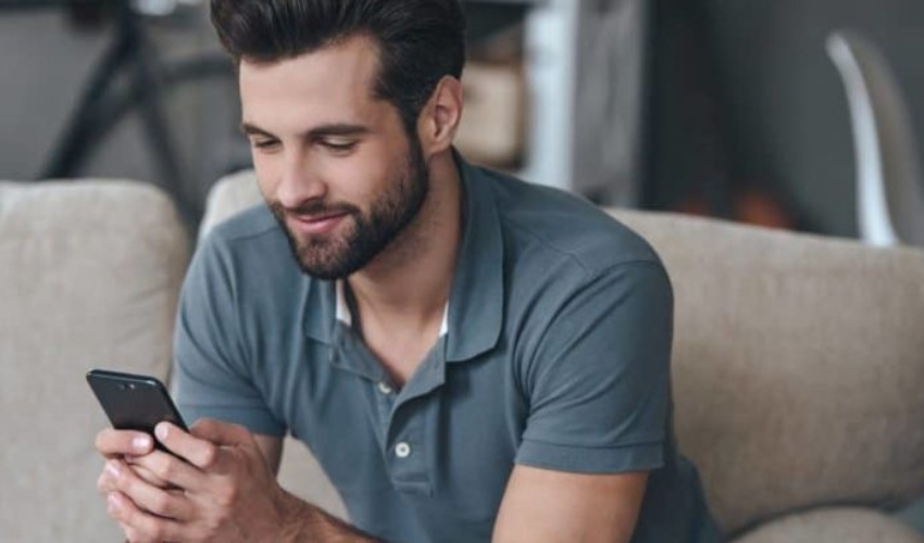 un homme est assis et touche au telephone