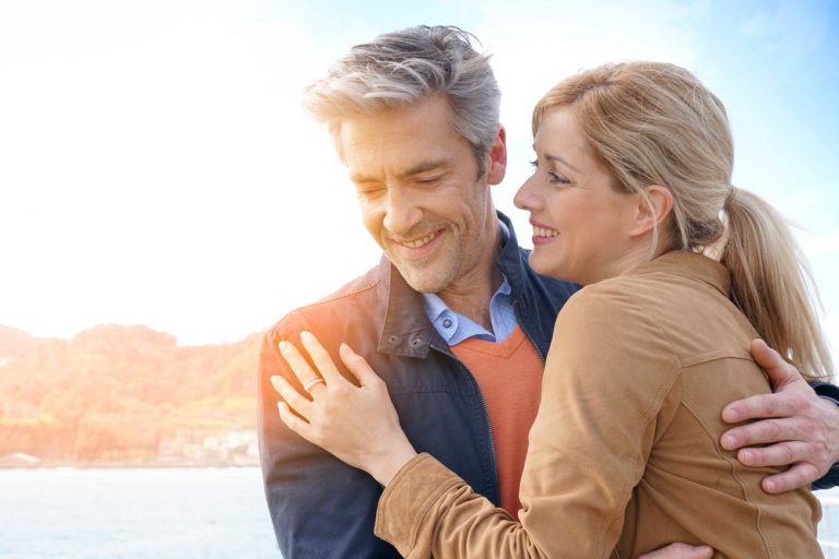 Couple d'âge moyen s'embrassant au bord de la mer