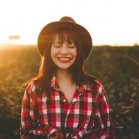 femme souriante portant un chapeau