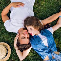 un couple romantique amoureux allongé sur l'herbe et câlins