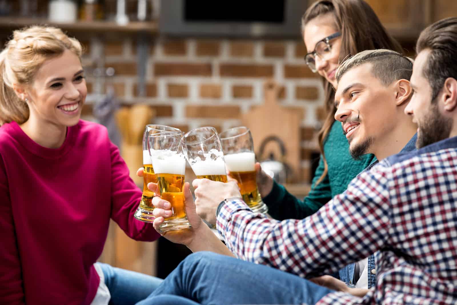 un homme et une femme buvant de la bière avec des amis