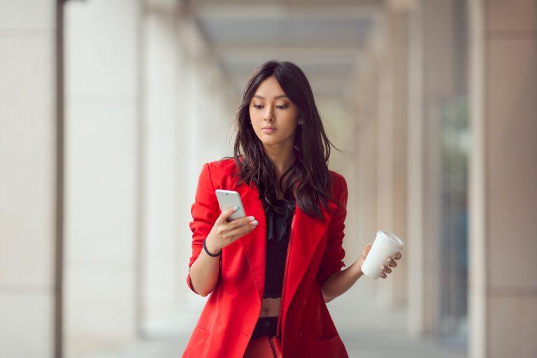 la jeune fille tient un smartphone dans ses mains