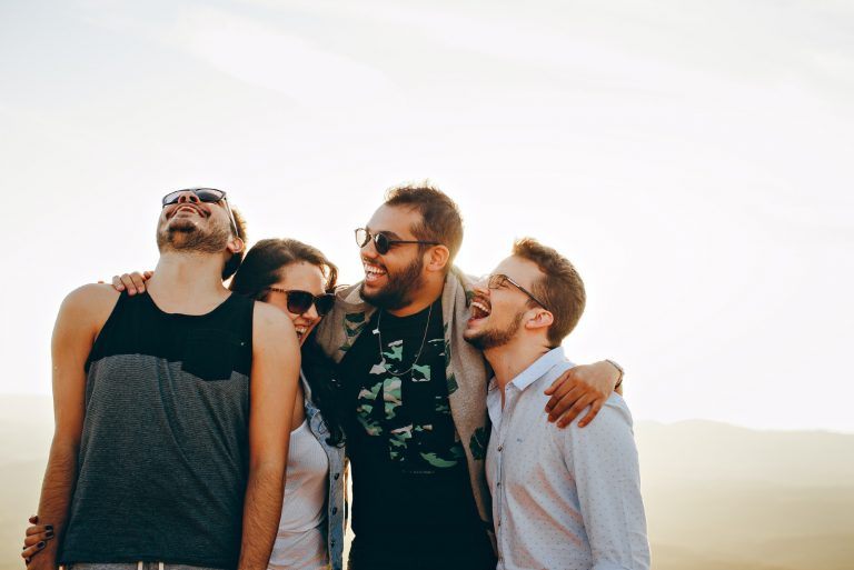 heureux amis étreindre tout en se tenant à l'extérieur