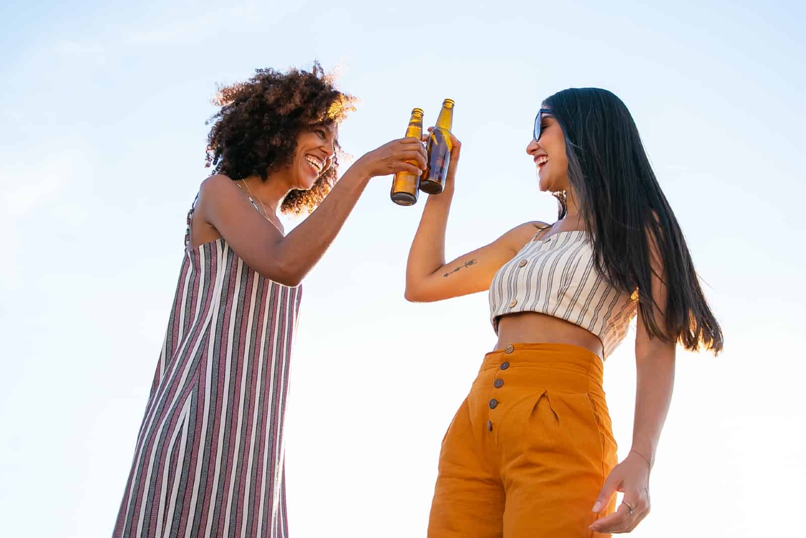 deux femmes buvant de la bière sur le toit