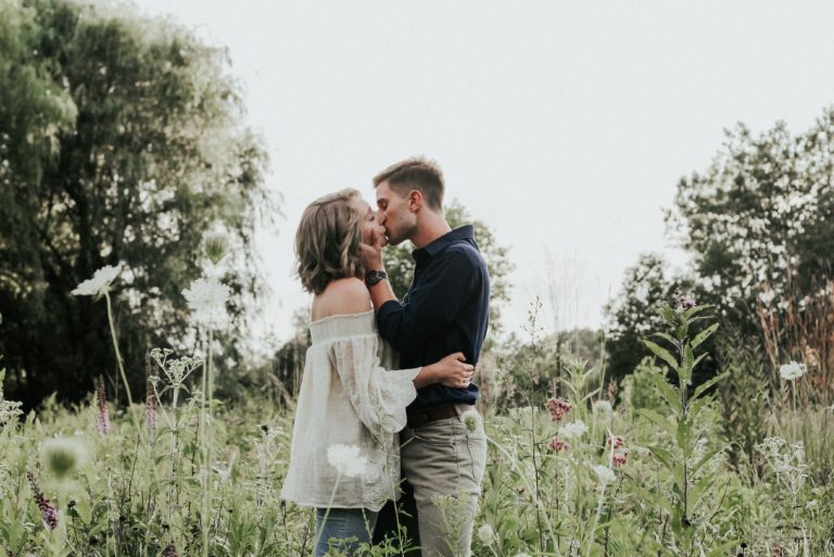 homme et femme s'embrassant sur un champ d'herbe