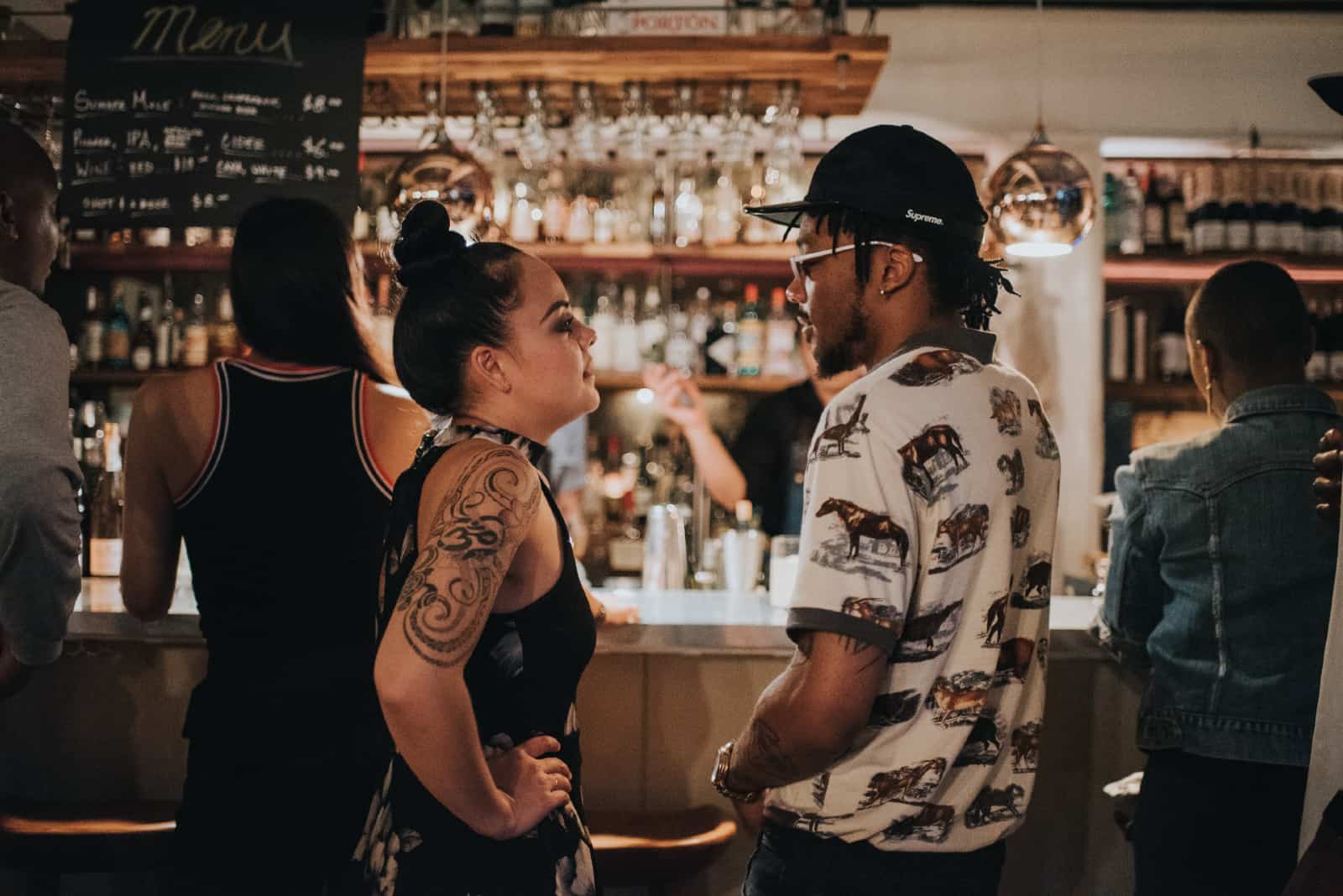 homme et femme se regardant dans les yeux dans un bar