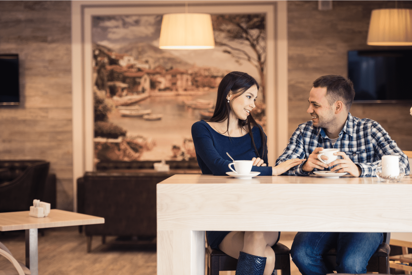 un homme et une femme souriants sont assis à table