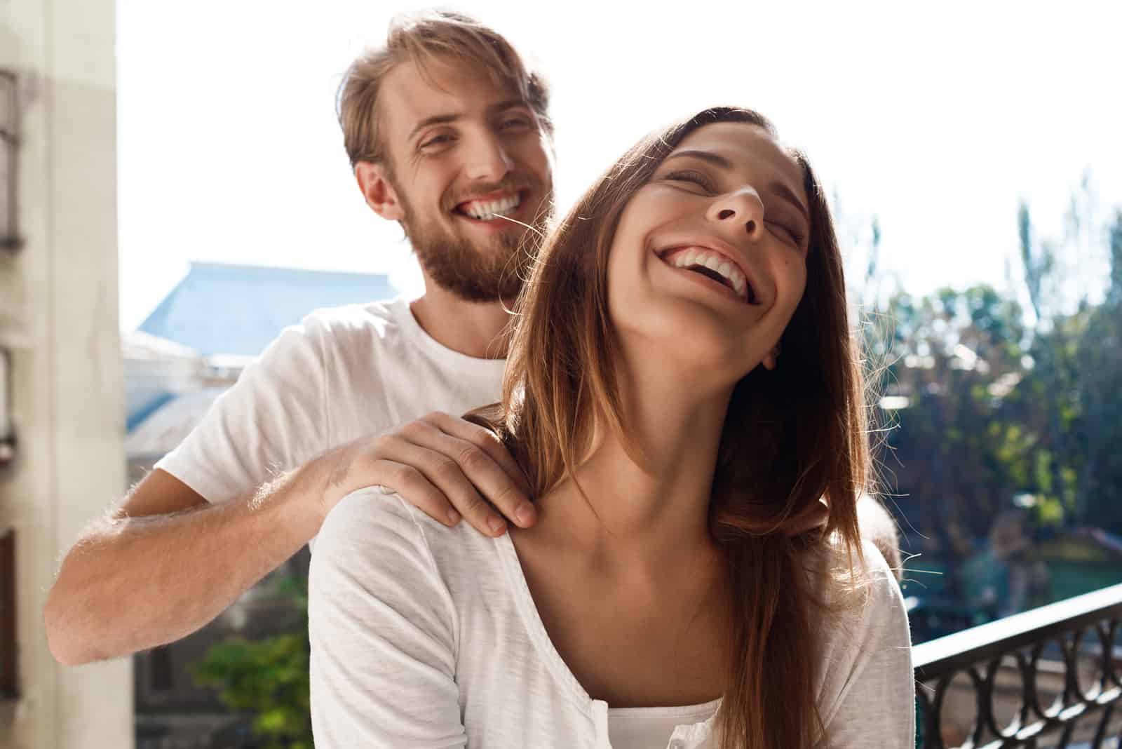 un homme souriant massant une femme