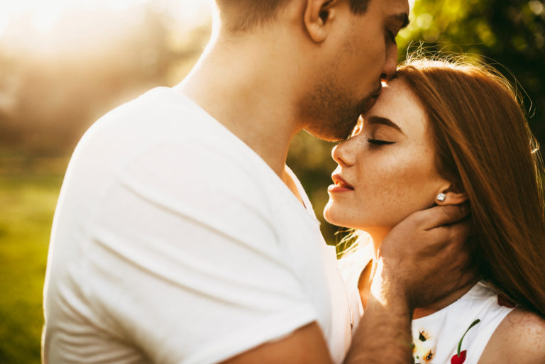 homme embrasse une femme sur le front