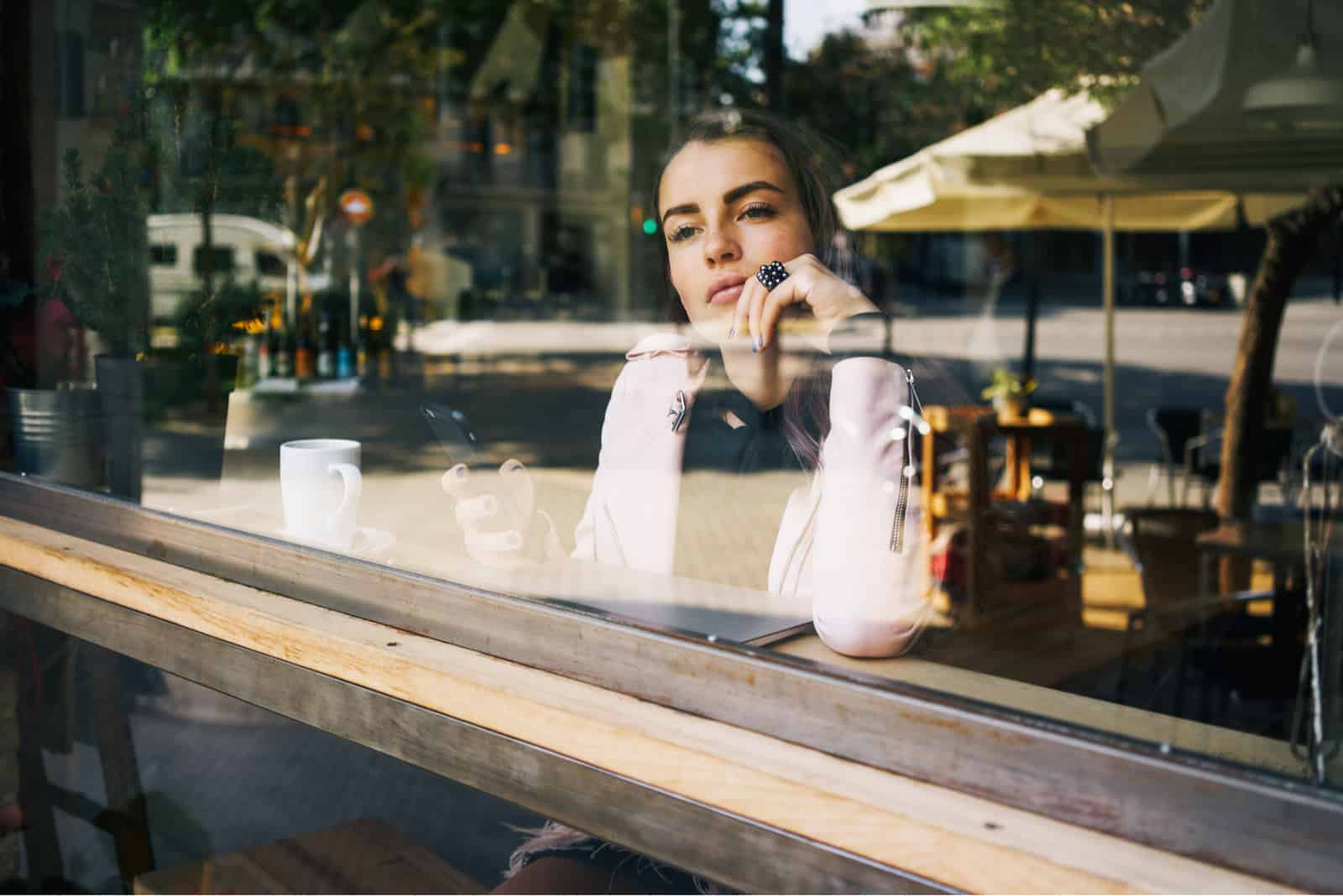 une femme imaginaire aux longs cheveux bruns est assise derrière un traîneau et tient un téléphone portable dans sa main