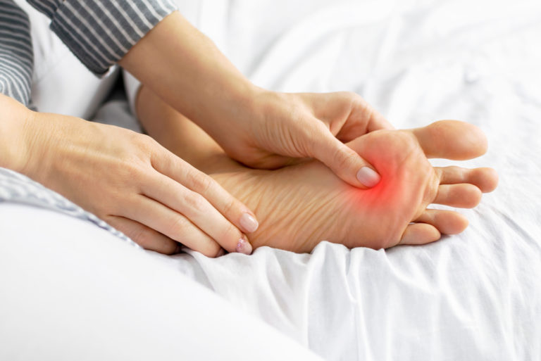 jeune femme ressentant de la douleur en appuyant sur son pied