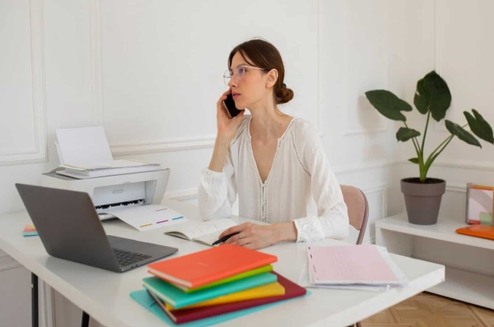 femme qui parle au téléphone en travaillant