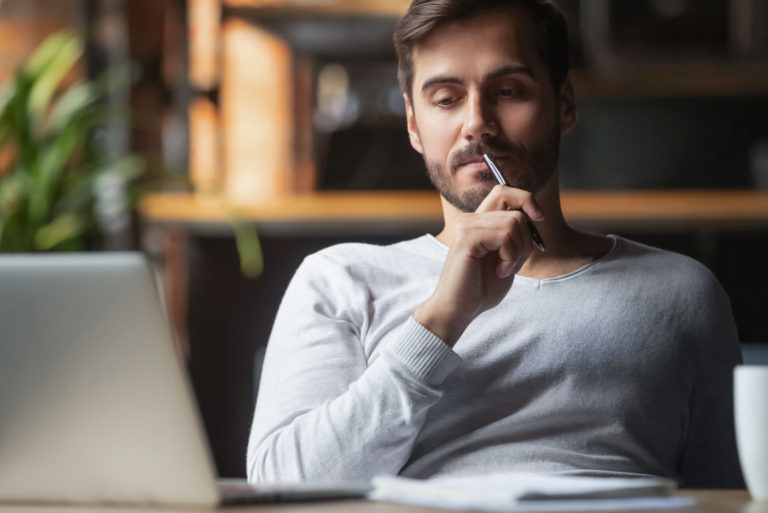 homme assis dans un café pensant