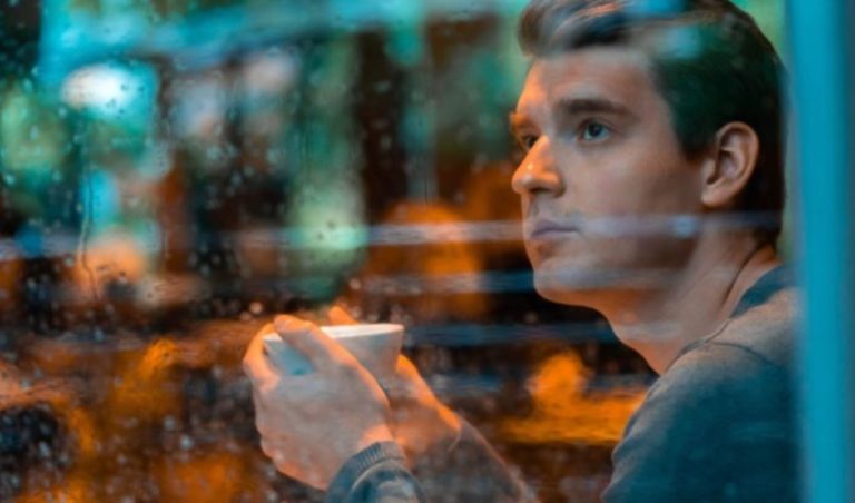 un homme pensif tient une tasse a la main