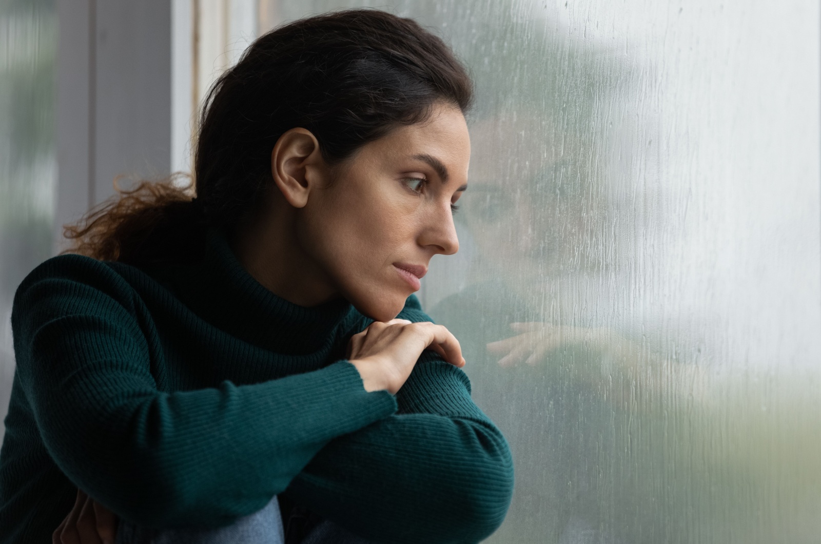 femme triste regardant par la fenetre